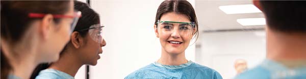 Female student doctor wearing safety glasses